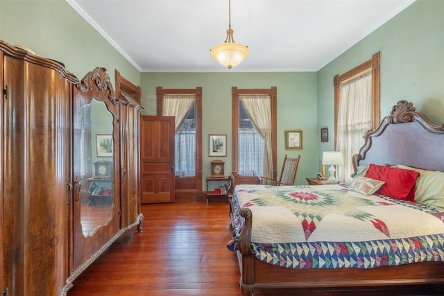 bedroom featuring dark wood-type flooring and ornamental molding