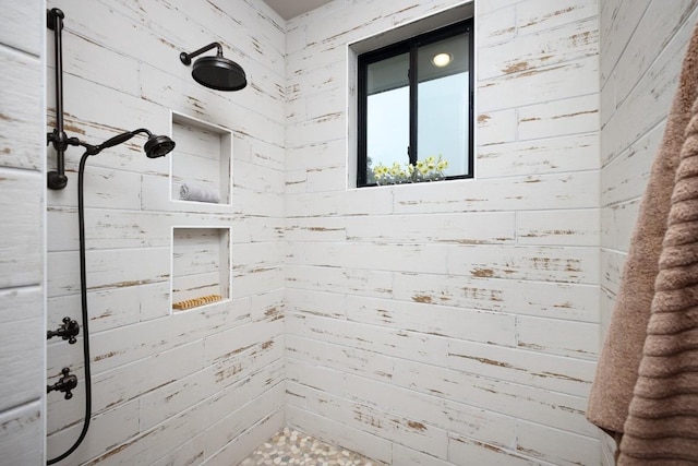 bathroom featuring wood walls and walk in shower