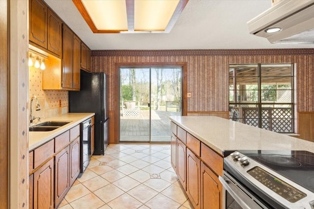 kitchen featuring light tile patterned flooring, sink, backsplash, and black appliances