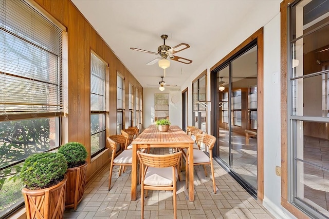 sunroom / solarium featuring ceiling fan