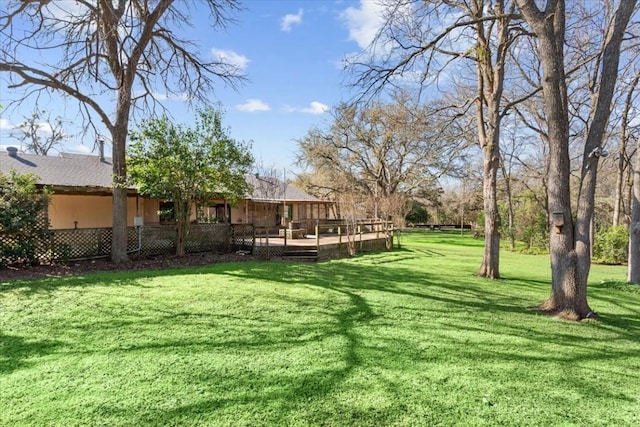 view of yard with a wooden deck