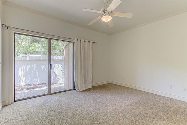 spare room featuring crown molding, carpet flooring, and ceiling fan