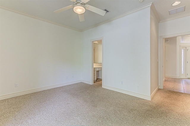 carpeted spare room with crown molding and ceiling fan