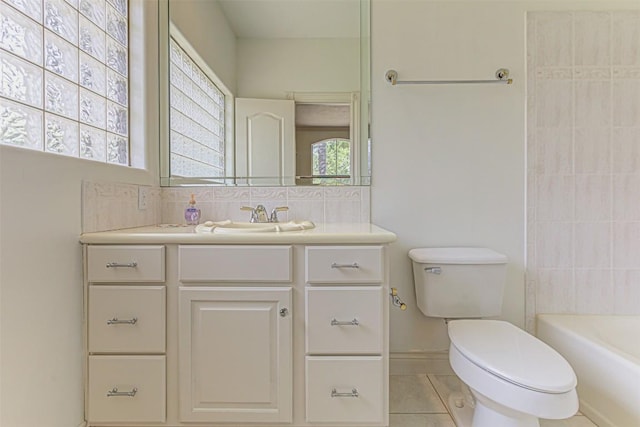 bathroom with vanity, tile patterned flooring, decorative backsplash, and toilet