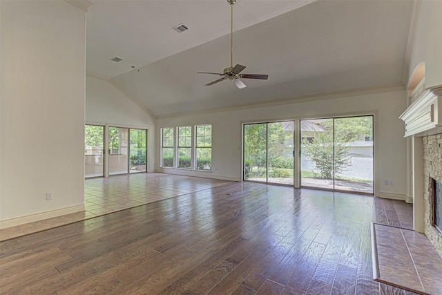 unfurnished living room featuring hardwood / wood-style flooring, ceiling fan, high vaulted ceiling, and a fireplace