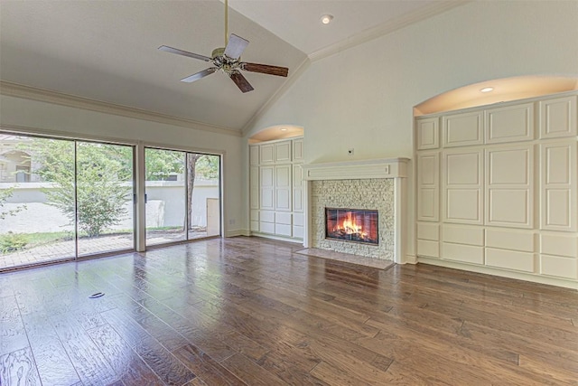 unfurnished living room featuring crown molding, high vaulted ceiling, ceiling fan, a fireplace, and hardwood / wood-style floors