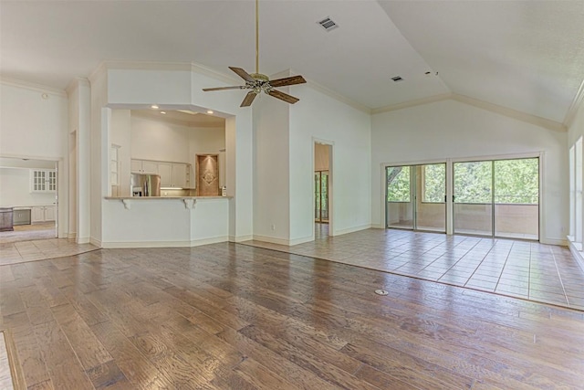 unfurnished living room featuring crown molding, high vaulted ceiling, ceiling fan, and light wood-type flooring