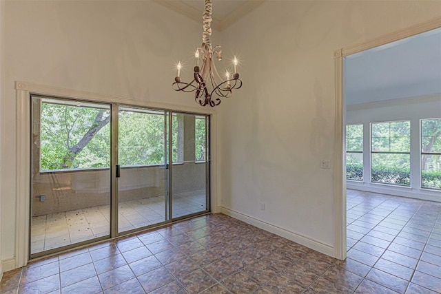 spare room with plenty of natural light and a chandelier