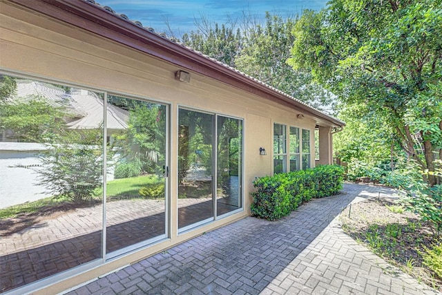 view of side of property with a patio area