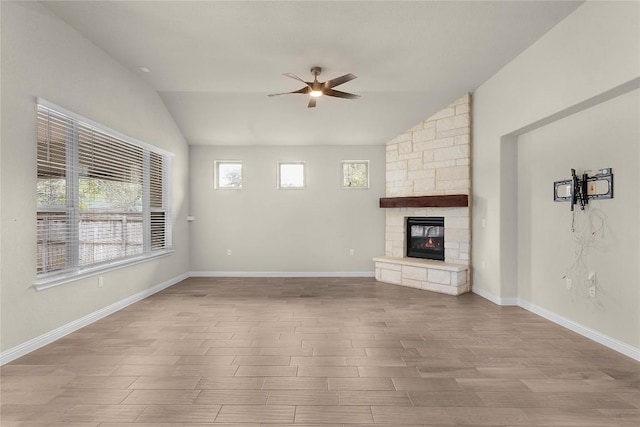 unfurnished living room with a fireplace, vaulted ceiling, ceiling fan, and light wood-type flooring