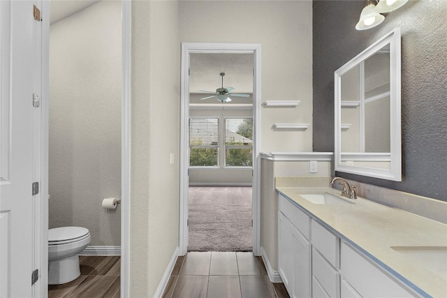 bathroom with vanity, ceiling fan, and toilet