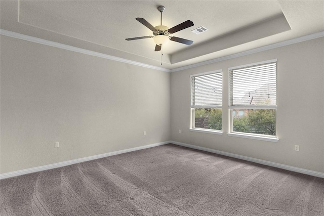 carpeted empty room with crown molding, ceiling fan, and a tray ceiling