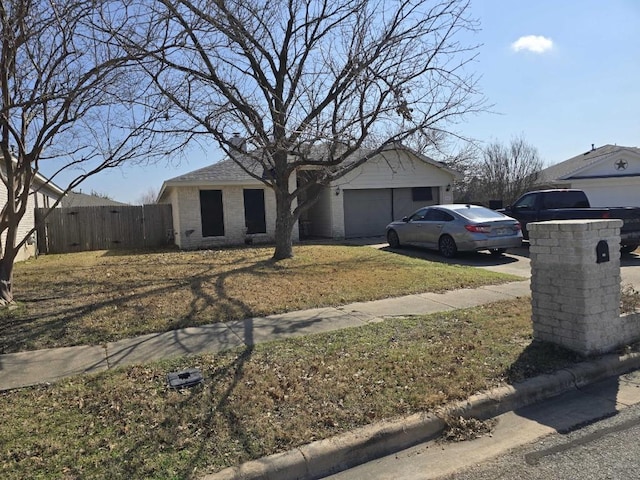 view of front of house with a garage and a front yard