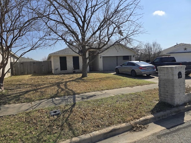 view of front of house featuring concrete driveway, a garage, and fence