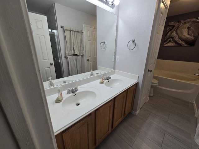 211 Valley Run Trl, Elgin, TX 78621 - full bath featuring double vanity, a garden tub, toilet, and a sink