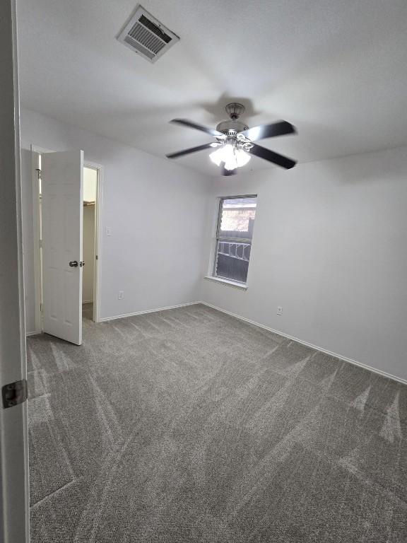 211 Valley Run Trl, Elgin, TX 78621 - carpeted empty room with baseboards, visible vents, and a ceiling fan