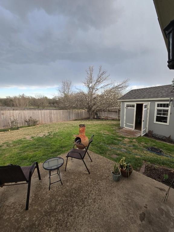 211 Valley Run Trl, Elgin, TX 78621 - view of yard with an outdoor structure, a patio, and a fenced backyard