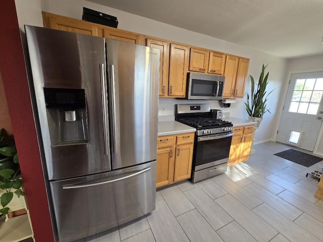 211 Valley Run Trl, Elgin, TX 78621 - kitchen with wood finish floors, stainless steel appliances, and light countertops