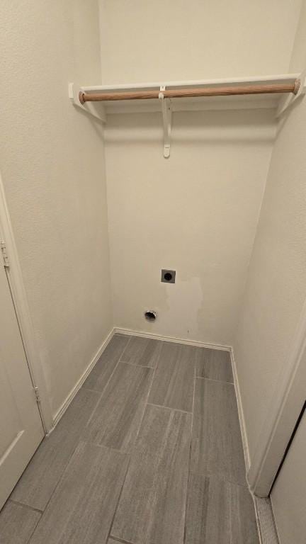 211 Valley Run Trl, Elgin, TX 78621 - clothes washing area with electric dryer hookup, baseboards, wood finish floors, and laundry area