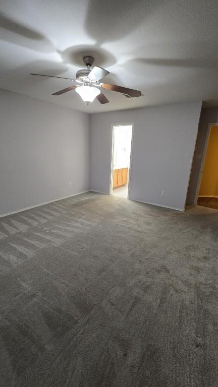 211 Valley Run Trl, Elgin, TX 78621 - unfurnished room featuring baseboards, a ceiling fan, and carpet