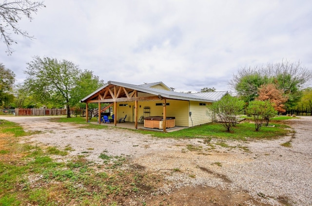 1000 Ledbetter St, Round Rock, TX 78681 - back of house featuring a hot tub and a metal roof
