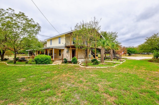 1000 Ledbetter St, Round Rock, TX 78681 - view of front of home featuring covered porch, a front yard, stairs, and stone siding
