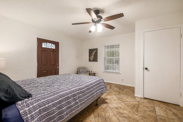 1000 Ledbetter St, Round Rock, TX 78681 - bedroom featuring a ceiling fan and a textured ceiling