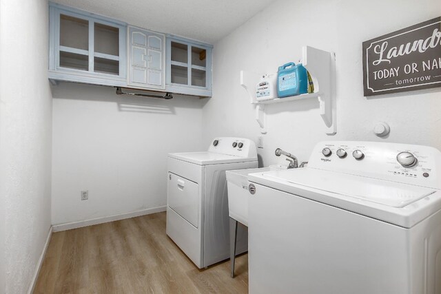 1000 Ledbetter St, Round Rock, TX 78681 - washroom featuring washing machine and dryer and light wood finished floors