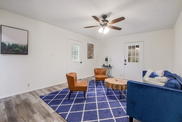 1000 Ledbetter St, Round Rock, TX 78681 - living area with wood finished floors, ceiling fan, and a textured ceiling