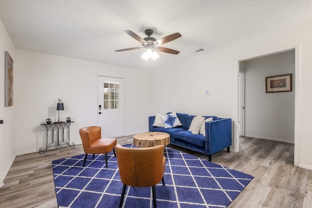 1000 Ledbetter St, Round Rock, TX 78681 - living room featuring wood finished floors, a ceiling fan, and a textured ceiling