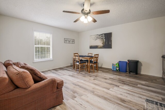 1000 Ledbetter St, Round Rock, TX 78681 - living area featuring light wood-type flooring, a ceiling fan, and a textured ceiling