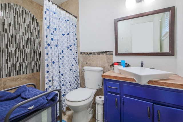 1000 Ledbetter St, Round Rock, TX 78681 - full bathroom with tile walls, vanity, wainscoting, and a shower with curtain