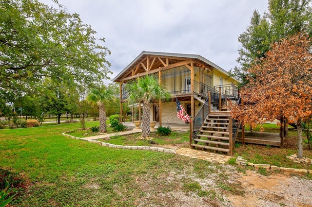 1000 Ledbetter St, Round Rock, TX 78681 - back of property with a yard, stairs, and a deck