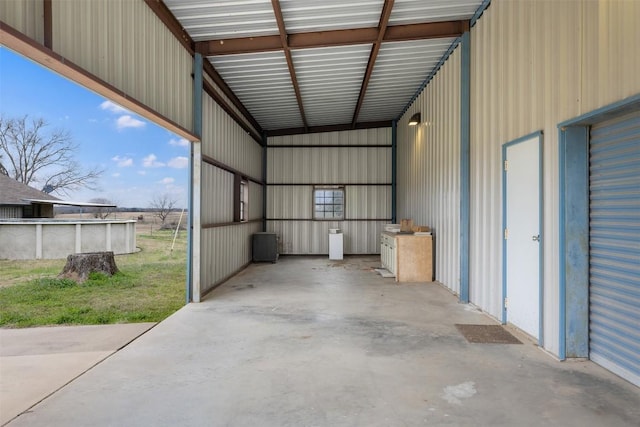 1252 County Road 106, Paige, TX 78659 - garage featuring an outdoor pool and metal wall
