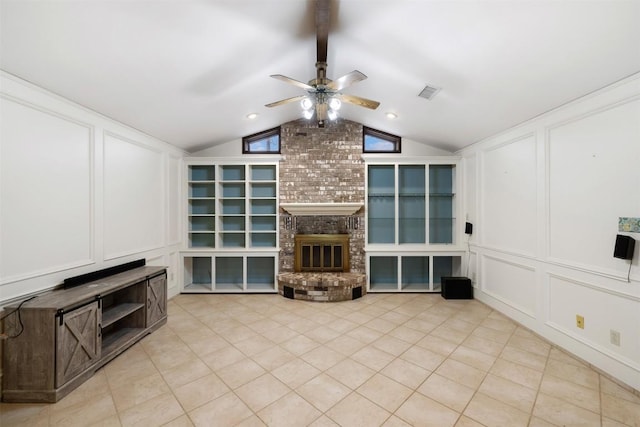 1252 County Road 106, Paige, TX 78659 - unfurnished living room with vaulted ceiling with beams, visible vents, a ceiling fan, a decorative wall, and a fireplace