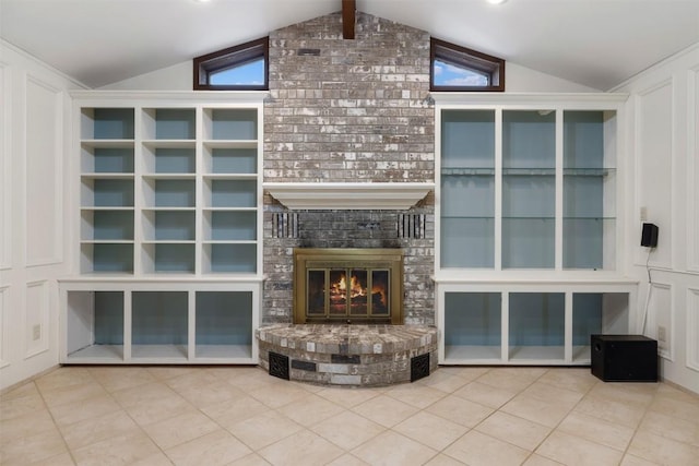 1252 County Road 106, Paige, TX 78659 - unfurnished living room featuring vaulted ceiling, a brick fireplace, and tile patterned floors