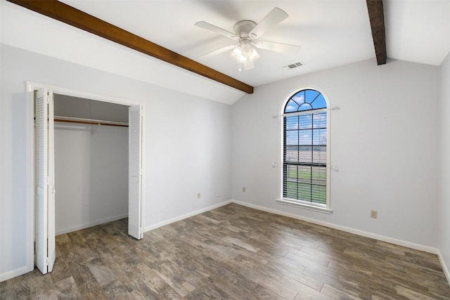 1252 County Road 106, Paige, TX 78659 - unfurnished bedroom featuring wood finished floors, visible vents, vaulted ceiling with beams, a closet, and baseboards