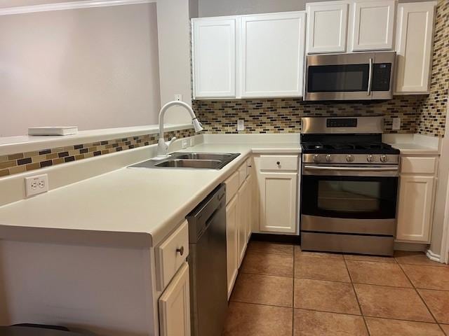 kitchen with white cabinetry, appliances with stainless steel finishes, sink, and decorative backsplash