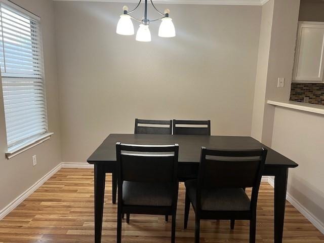 dining room featuring an inviting chandelier and light hardwood / wood-style floors