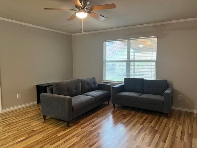 living room featuring crown molding, ceiling fan, and wood-type flooring