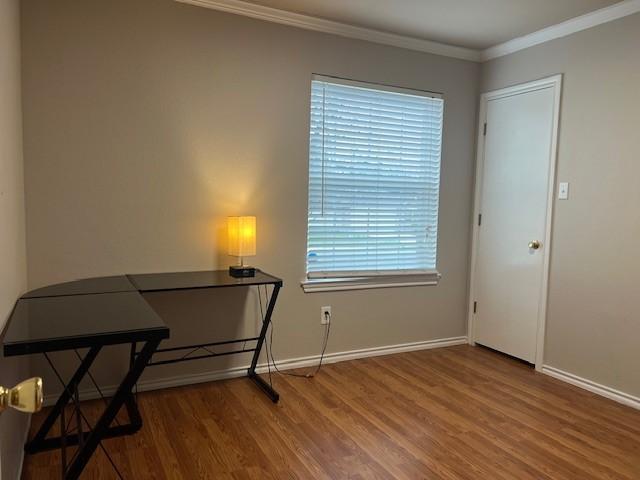 interior space with wood-type flooring and ornamental molding