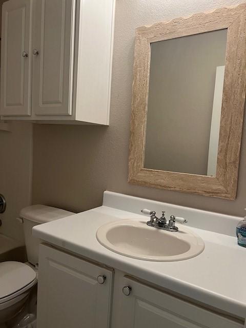 full bathroom with vanity, separate shower and tub, and toilet