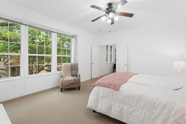 bedroom with light colored carpet and ceiling fan