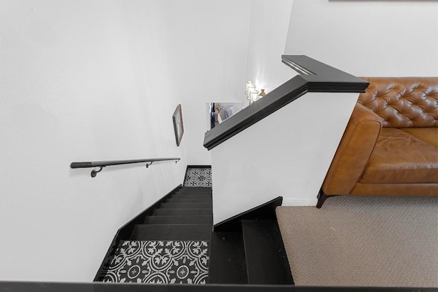 staircase featuring carpet flooring