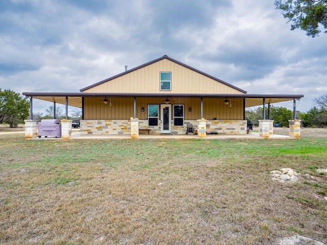 back of property featuring a patio and a lawn