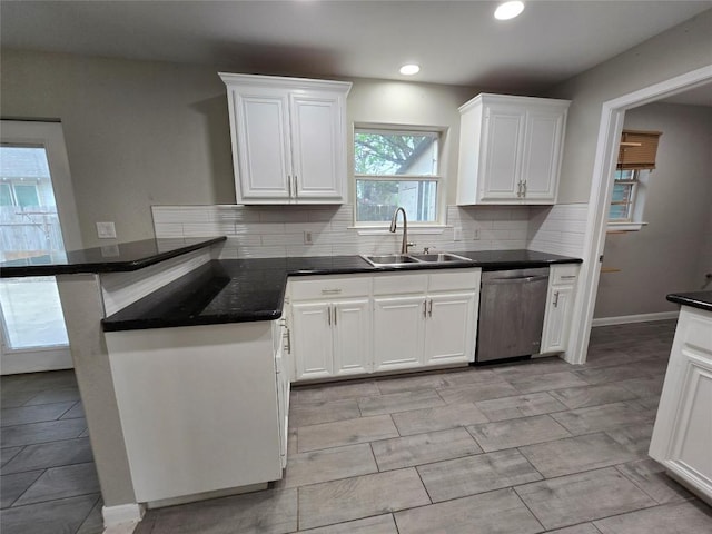 177 E Davilla St, Bartlett, TX 76511 - kitchen with a peninsula, a sink, dark countertops, white cabinetry, and dishwasher