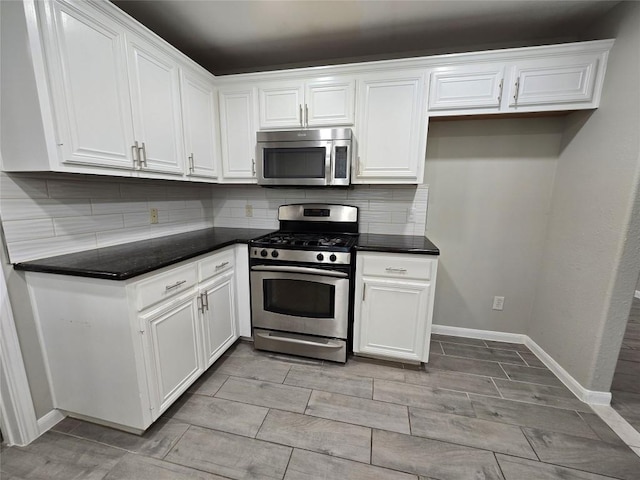 177 E Davilla St, Bartlett, TX 76511 - kitchen featuring white cabinets, stainless steel appliances, tasteful backsplash, dark countertops, and baseboards