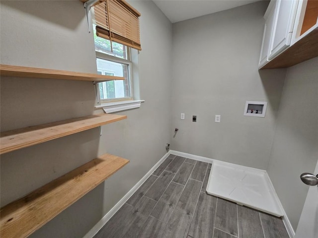 177 E Davilla St, Bartlett, TX 76511 - washroom featuring hookup for an electric dryer, hookup for a washing machine, baseboards, cabinet space, and wood finish floors