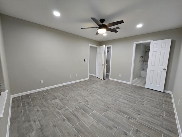 177 E Davilla St, Bartlett, TX 76511 - unfurnished bedroom with ensuite bathroom, baseboards, visible vents, recessed lighting, and wood finish floors