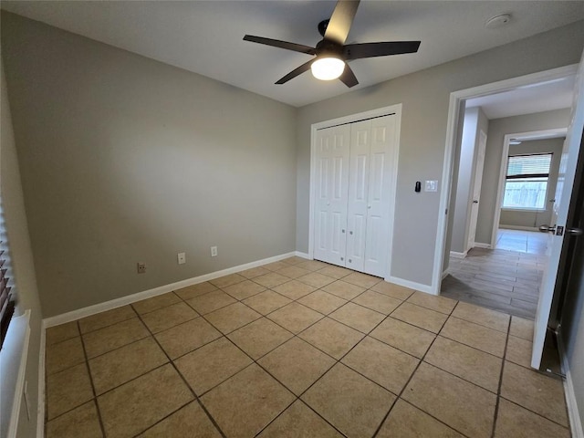 177 E Davilla St, Bartlett, TX 76511 - unfurnished bedroom featuring a ceiling fan, baseboards, a closet, and light tile patterned floors